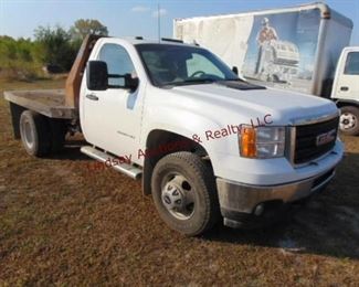 2013 GMC 3500HD 4x4, 6.0 v8 gas automatic,Showing 158,395 miles, pwr steering, pwr brakes, pwr locks, cruise, AMFM CD, air, trailer tow pckg., 8' flat bed w/ gooseneck ball, cloth interior, Vin # 1GT322CG1DF230886 (TRUCK NEEDS A RADIATOR & REAR BRAKE CALIPER/ BRAKES WEAK) Starts/Runs/Drives