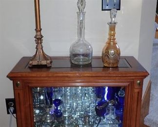 SHORT LIGHTED CURIO CABINET - PENCIL LAMP - DECANTERS