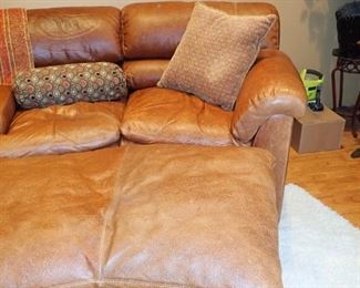 LARGE SUPPLE LEATHER COUCH W/  2 -- LEATHER OTTOMANS - ONE OTTOMAN HAS STORAGE  -- COUCH IS 14' LONG  28" DEEP -- 