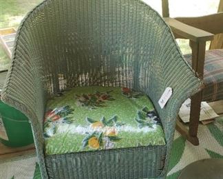 Wicker chair with cushion, rug
