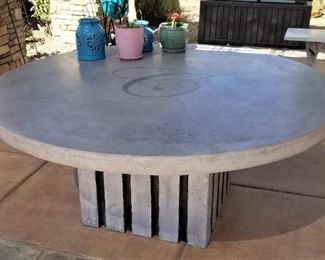 Very large round cement outdoor patio table.