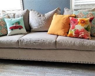 Wonderful neutral colored sofa with a matching loveseat. Colorful pillows to choose from.