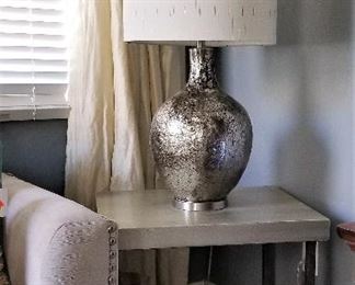 Modern silver lamp and silver wood and metal modern side table.