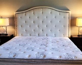King bed and king mattress. Bedside tables and mid-century modern lamps.