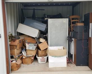 storage unit contents refrigerator stove shelving speakers books old bicycle wooden chairs, rolling fertilizer spreader, lots more unknown we can't see all of it.  