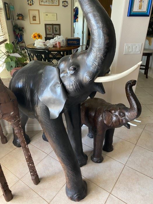 Two large elephant statues. Leather 5 feet and 3 feet tall. Beautiful!