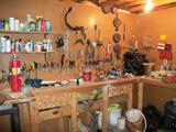 WORKBENCH AND TABLE FULL OF TOOLS