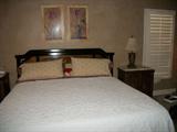 King size bed with oriental design on headboard