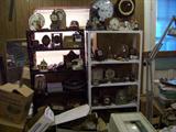 SHELVES FULL OF SMALL CLOCKS