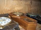 SHELVES FULL OF WALL CLOCKS.