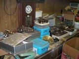 WORK BENCH FULL OF CLOCK MOVEMENTS.