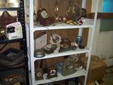 SHELF FULL OF SMALL CLOCKS.