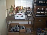 MINITURE CLOCK COLLECTION, VHS, DVD, AND CASSETTE TAPES.