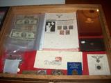 CASE FULL OF FOREIGN MONEY, COINS, PROOF SETS, NAZI STAMPS AND COIN. LARGE SELECTION OF HITLER STAMPS FULL SHEETS.BRASS BELT BUCKLES.