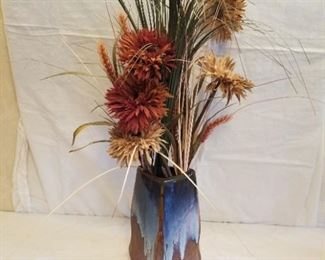 blue and brown ceramic vase with flowers