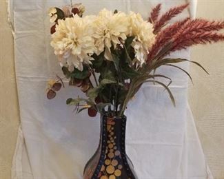 large black and gold vase with flowers