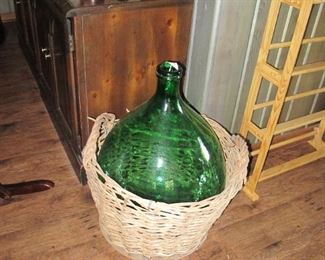 Huge water bottle in original wicker basket.