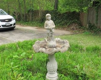 Bird bath and statue of girl holding a frog.