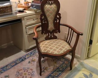 Interesting chair and view of small pink and blue area rug, Chinese