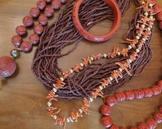 Assorted cinnabar, coral and quartz beads necklaces, Cinnabar bangle.