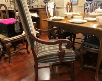 Table and chairs are not available, but there are several sets of white dinnerware. Preserved roses can be seen in the back left part of the photo.