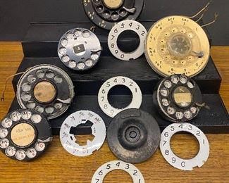 An assortment of early telephone rotary dial parts...To Register and To Bid go to https://capitolsalesservices.hibid.com... 