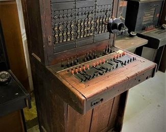 Antique Western Electric telephone operators free standing switchboard cord board with hanging transmitter, 1910s....To Register and To Bid go to https://capitolsalesservices.hibid.com... 