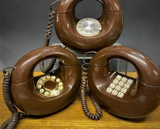Three examples of vintage mid century modern Sculptura Telephone from Western Electric, rotary dial, push button, and a push button in the style of a rotary phone.  ...To Register and To Bid go to https://capitolsalesservices.hibid.com... 