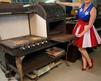 Mary Lou demonstrating the new for 1910 electric oven by Western Electric.     ...To Register and To Bid go to https://capitolsalesservices.hibid.com... 
