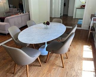 Oval Sarinan style tulip table and six West Elm leather dining chairs. 