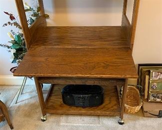 #16 Oak shelving with cabinet with drop down desk area, and on casters 30"x19.5"x61" $60.00