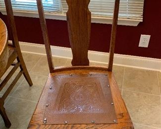 #40 Antique oak table on casters, 4 chairs with embossed leather seats and 2 leaves. 42"-58"x42"x30" SOLD