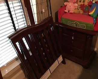 The crib part of the bed, nightstand