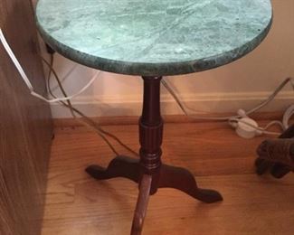 Round wood table with granite top.