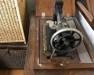 Vintage White Rotary sewing machine in cabinet.