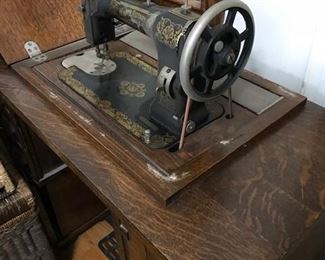 Vintage White Rotary sewing machine in cabinet.