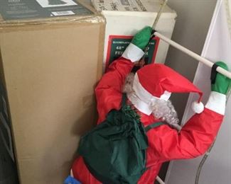 Santa on ladder and Christmas trees in box.