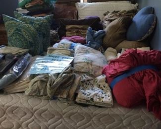 Three-piece bedroom set and linens.