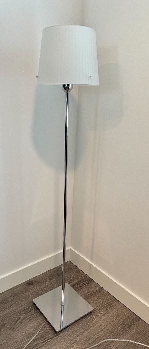 Item 32:  Jupe Classic Floor Lamp by Artemide. Shade in molded, ribbed, sanded glass. Base and socket cover in polished aluminum.  Designed by Peclar Nalbandian & Guy Burr.- 59": $525