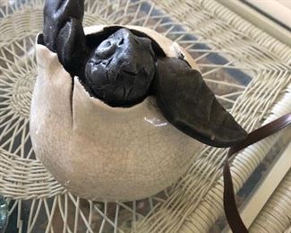 Sweet ceramic turtle emerging from a shell