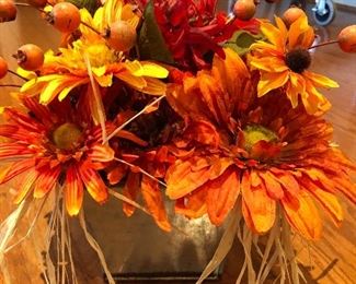 This is a very pretty autumn arrangement in a tin container