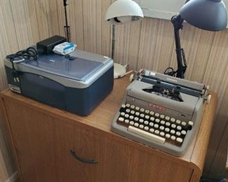 Vintage Royal Quiet DeLuxe typewriter.  HP Printer.  Nice 2 drawer file cabinet.  Desk lamps.