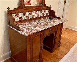 Antique Victorian Era marble top vanity dresser with art nouveau tile backsplash and hand carved detail 