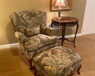 Antique re-upholstered curved wingback club chair and matching ottoman