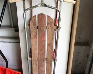 Vintage sled with wood seat and metal frame