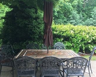 Heavy duty wrought iron table and chairs.  Sunbrella and stand sold separately. 
