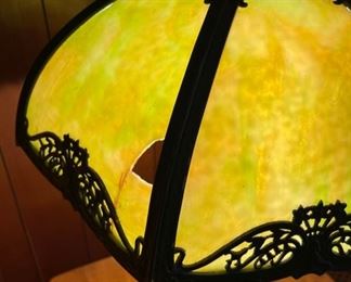 Antique slag glass table lamp. There is one broken panel as photographed
