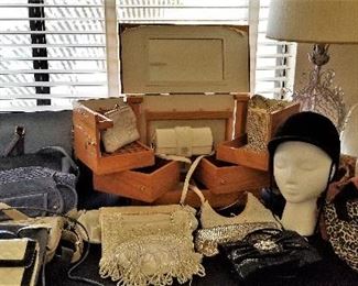 Purses and neat scrolled metal table lamp, another jewelry box and a riding hat.