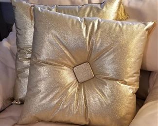 Gold Hollywood pillows.
