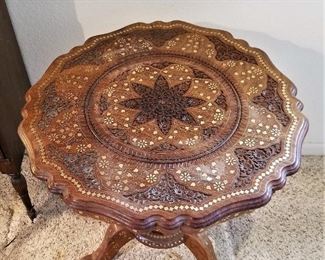 Beautiful carved wood inlay round vintage table top view.
